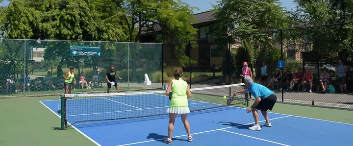 Pickleball players pictured by Pickleball Kelowna on its outdoor-court guide. The source does not identify the court or photo date.